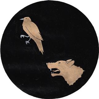 House Ravenwolf logo displaying a textured black circle with a gold raven rampant in the upper left and a gold wolf head in the lower right. The raven is standing with one leg raised. The wolf head is mouth open in a snarl. Both animals  face left.